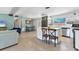 Inviting kitchen flows seamlessly into living area offering stainless appliances and bar seating at 6931 Magellan Way, Sarasota, FL 34243