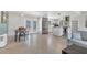 Bright living space with modern stainless steel fridge and access to the kitchen area at 6931 Magellan Way, Sarasota, FL 34243