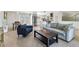 Open-concept living space with kitchen, dining, and living areas with terrazzo flooring at 6931 Magellan Way, Sarasota, FL 34243