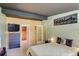 Well-lit main bedroom showcasing an open closet, a TV, and art at 6931 Magellan Way, Sarasota, FL 34243
