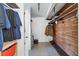 Spacious walk-in closet with custom wood shelving, hanging clothes, and ample storage space at 6931 Magellan Way, Sarasota, FL 34243