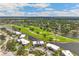 Aerial view of this property showcasing the prime golf course community and water views at 7193 W Country Club N Dr # 137, Sarasota, FL 34243