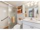 Well-lit bathroom with a glass shower and vanity storage at 7193 W Country Club N Dr # 137, Sarasota, FL 34243