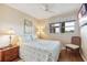 Comfortable bedroom with wooden floors, a serene window view, and a ceiling fan at 7193 W Country Club N Dr # 137, Sarasota, FL 34243