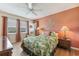 Cozy bedroom featuring a queen-size bed, ceiling fan, and warm lighting at 7193 W Country Club N Dr # 137, Sarasota, FL 34243
