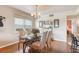 Dining room with a chandelier, natural light, and a view of the kitchen and living areas at 7193 W Country Club N Dr # 137, Sarasota, FL 34243