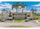 Charming two-story condo with a well-manicured lawn, mature palms, and assigned parking spaces at 7193 W Country Club N Dr # 137, Sarasota, FL 34243