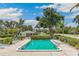 Inviting community pool surrounded by lush greenery and lounge chairs at 7193 W Country Club N Dr # 137, Sarasota, FL 34243