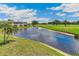 Scenic water view with lush landscaping and building on a bright, sunny day at 7193 W Country Club N Dr # 137, Sarasota, FL 34243