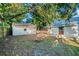 An exterior shot showcasing a backyard with a firepit and shed at 720 37Th W St, Bradenton, FL 34205