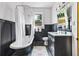Bathroom showcasing a vintage tub, updated vanity, paneled walls, and a bright window at 720 37Th W St, Bradenton, FL 34205