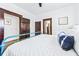 A bedroom featuring white walls, wood trim and doors, and a bed with white bedding at 720 37Th W St, Bradenton, FL 34205