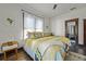 Bright bedroom with white walls, wooden floors, and stylish yellow and white bedding with throw pillows at 720 37Th W St, Bradenton, FL 34205