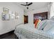 Bedroom with dark wood trim and flooring, white walls and a ceiling fan at 720 37Th W St, Bradenton, FL 34205