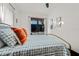 Bedroom with a television, a bed with patterned pillows and white walls at 720 37Th W St, Bradenton, FL 34205