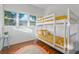 Bedroom featuring white bunk beds with gold bedding and throw pillows at 720 37Th W St, Bradenton, FL 34205