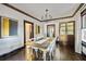Elegant dining room with a large table, modern chandelier, and stylish decor at 720 37Th W St, Bradenton, FL 34205