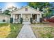 Charming home with inviting front porch, brick pathway and black and white color scheme at 720 37Th W St, Bradenton, FL 34205