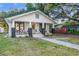 Exterior front view of the home with a well-manicured lawn and spacious porch at 720 37Th W St, Bradenton, FL 34205