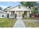 Charming home with a spacious front porch, manicured lawn, and stone walkway at 720 37Th W St, Bradenton, FL 34205