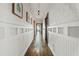 Long hallway with wood floors and decorative wainscoting at 720 37Th W St, Bradenton, FL 34205