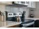 A stainless steel range stands next to a knife block and a black blender on a marble-look countertop at 720 37Th W St, Bradenton, FL 34205