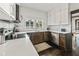 Kitchen featuring stainless steel appliances, white marble backsplash and white countertops on dark wood cabinets at 720 37Th W St, Bradenton, FL 34205