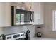 Stainless steel microwave above a stainless steel range next to a marble look backsplash and white cabinets at 720 37Th W St, Bradenton, FL 34205