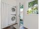 A laundry room with a stacked washer and dryer and access to the backyard at 720 37Th W St, Bradenton, FL 34205