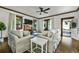 Spacious living room featuring hardwood floors, neutral furniture, and a view of the front yard at 720 37Th W St, Bradenton, FL 34205