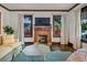 Inviting living room with a fireplace, hardwood floors, and large windows allowing natural light at 720 37Th W St, Bradenton, FL 34205