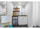 View of the kitchenette in the studio with white cabinets, stainless fridge, and modern finishes at 720 37Th W St, Bradenton, FL 34205