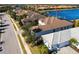 Aerial view of a lakeside property with manicured lawns and a tile roof, showcasing its prime location at 7208 Prestbury Cir, Bradenton, FL 34202