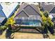 Bird's eye view of a screened pool, lush landscaping, and private backyard, perfect for relaxation and entertainment at 7208 Prestbury Cir, Bradenton, FL 34202