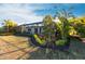 A beautifully landscaped backyard with a screened lanai, offering a serene outdoor living space at 7208 Prestbury Cir, Bradenton, FL 34202