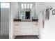 Modern bathroom vanity with a vessel sink, stylish mirror, and contemporary lighting fixtures at 7208 Prestbury Cir, Bradenton, FL 34202