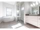 Bright bathroom featuring a modern tub, glass shower, and sleek vanity with stylish fixtures at 7208 Prestbury Cir, Bradenton, FL 34202