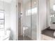 Contemporary bathroom with a glass shower featuring pebble flooring, alongside a soaking tub and vanity at 7208 Prestbury Cir, Bradenton, FL 34202