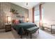 Stylishly decorated bedroom with unique wallpaper and comfortable furnishings at 7208 Prestbury Cir, Bradenton, FL 34202