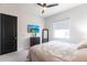 Cozy bedroom featuring a comfortable bed, dresser with a TV, a mirror, and natural light at 7208 Prestbury Cir, Bradenton, FL 34202