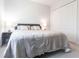 Neutral bedroom with a large bed, side tables with lamps, and a double door closet at 7208 Prestbury Cir, Bradenton, FL 34202