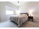 Neutral bedroom featuring a large bed, side tables with lamps, and a bright window at 7208 Prestbury Cir, Bradenton, FL 34202