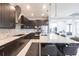Modern kitchen features dark wood cabinets, stainless steel appliances, and a spacious island with granite countertops at 7208 Prestbury Cir, Bradenton, FL 34202