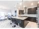 A sleek kitchen island and stainless-steel appliances create a modern and functional cooking space at 7208 Prestbury Cir, Bradenton, FL 34202