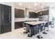 Modern kitchen with stone counters, a large island with seating, stainless appliances, and sleek dark cabinetry at 7208 Prestbury Cir, Bradenton, FL 34202
