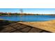 Scenic view of a tranquil lake surrounded by homes and grassy shoreline, a peaceful neighborhood setting at 7208 Prestbury Cir, Bradenton, FL 34202