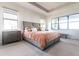 Bright, modern main bedroom with a large bed, ample natural light, and tray ceiling at 7208 Prestbury Cir, Bradenton, FL 34202