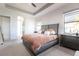 Main bedroom features a large bed, accent pillows, and large windows for natural light at 7208 Prestbury Cir, Bradenton, FL 34202