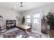 Office space features a desk, a ceiling fan, large windows, and built-in shelving for a functional workspace at 7208 Prestbury Cir, Bradenton, FL 34202