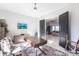 Home office space with a modern desk, a patterned rug, and a view into an open-concept living area at 7208 Prestbury Cir, Bradenton, FL 34202